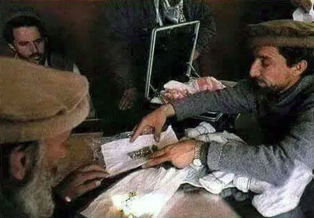 Photo showing Ahmad Shah Massoud selling precious stones.